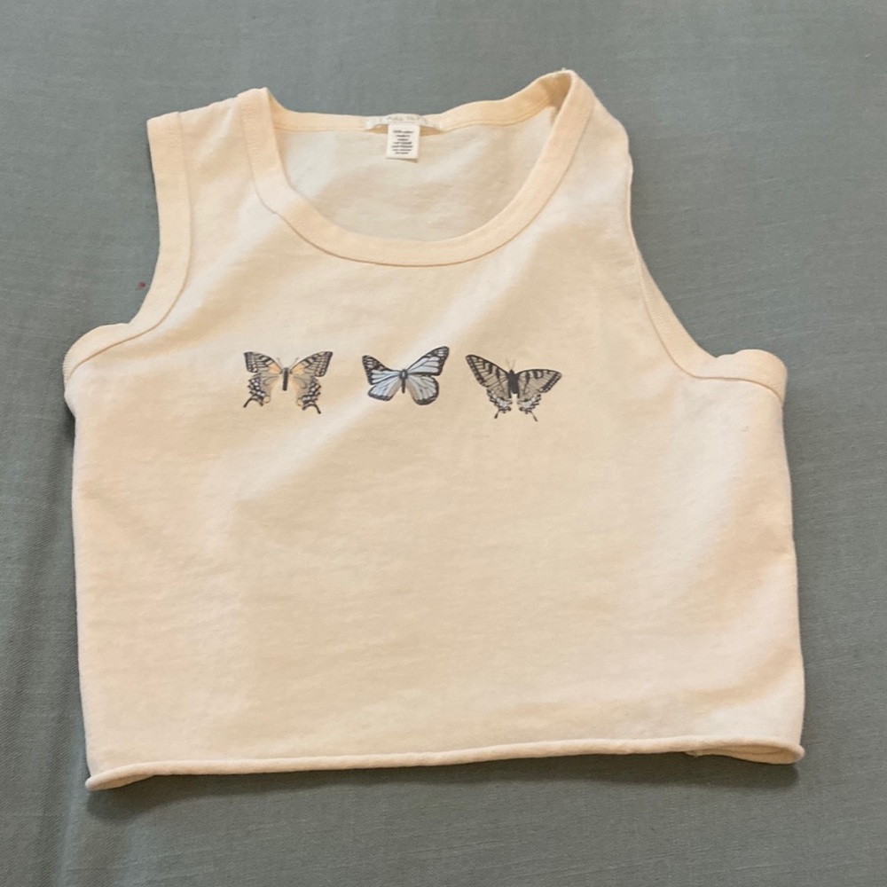 Tan/cream colored, loose tank top.